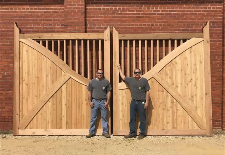 Men in front of large wooden gates